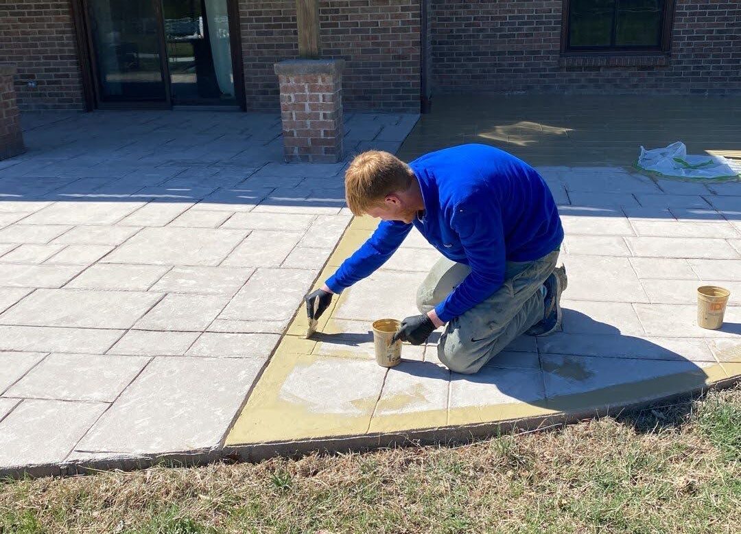 Applying a basecoat and chip broadcasting to a concrete floor.